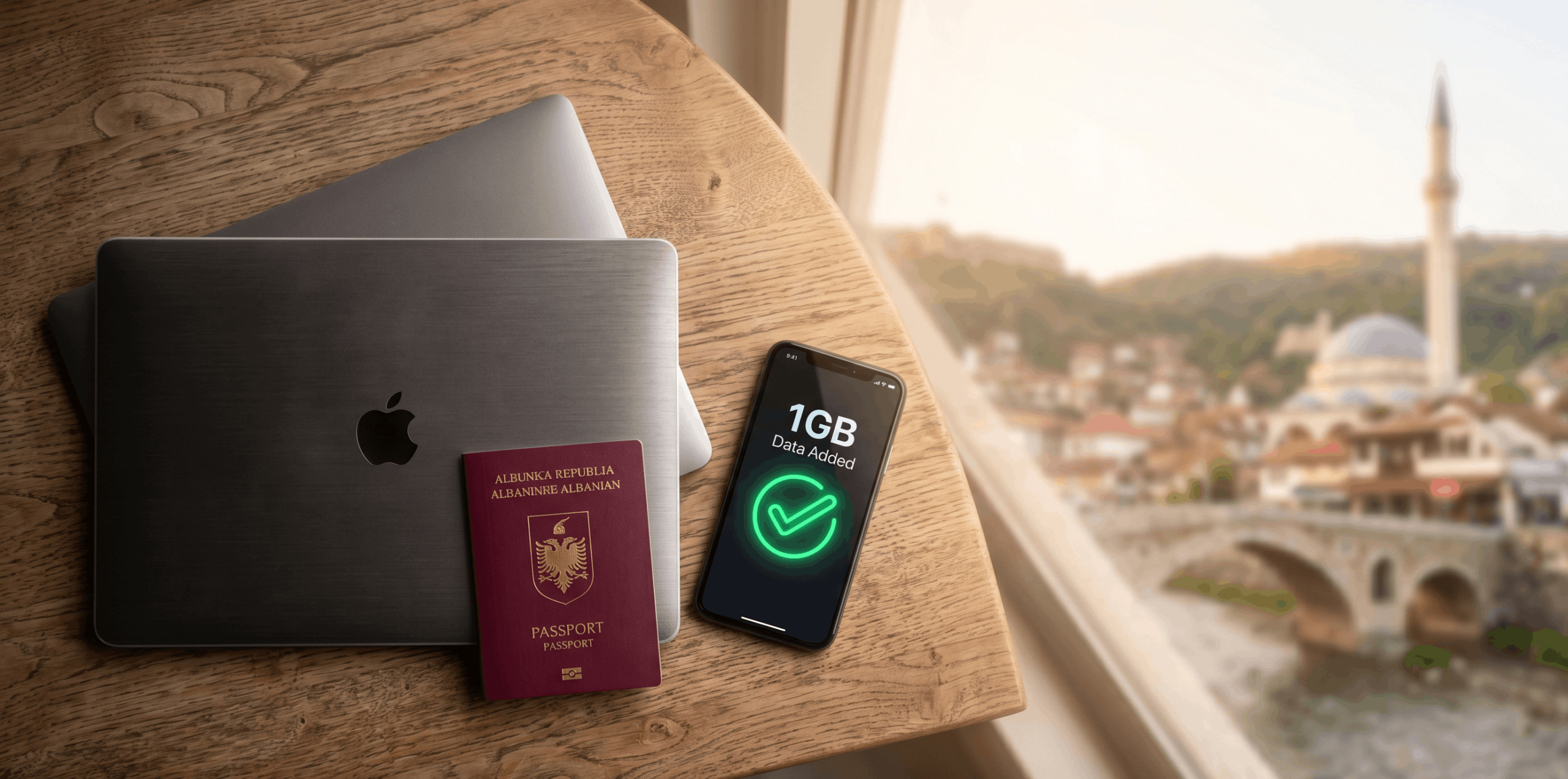 A digital nomad's workspace with a smartphone showing a free 1GB eSIM activation.